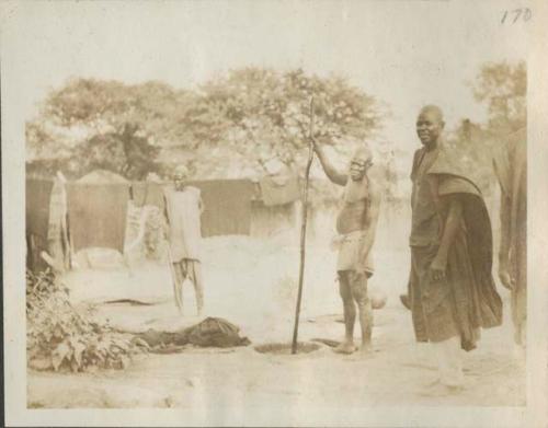 Men standing next to dye pits