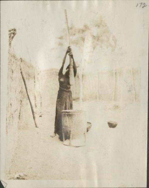 Woman pounding grain