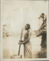 Woman pounding grain