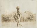 Woman carrying water and bowls