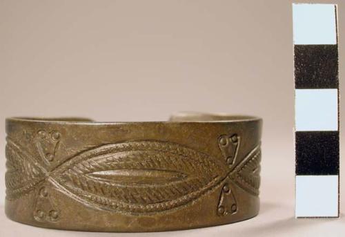 Silver bracelet. Stamped and etched designs on exterior. 6.2x4.4 cm.