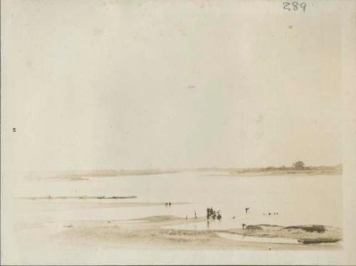 People bathing and collecting water at Chari River