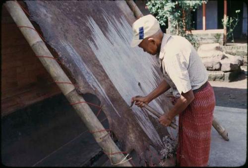 Scraping leather for wayang kulit