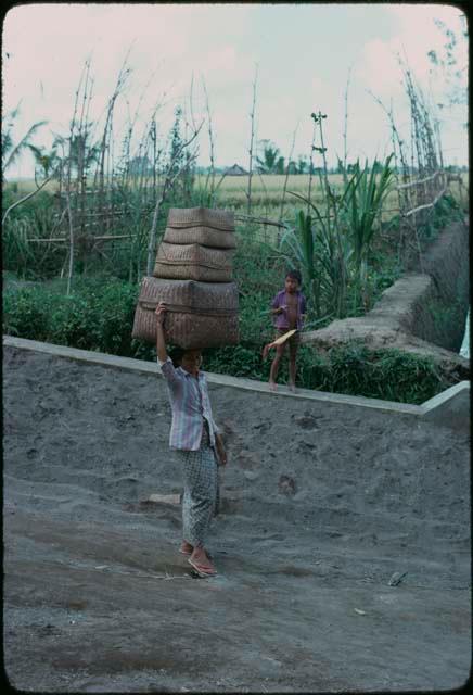 Person carrying boxes on their head