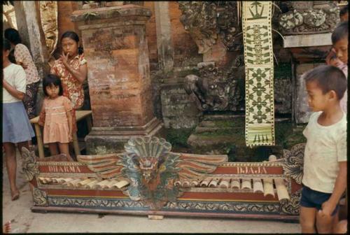 People standing next to gamelan