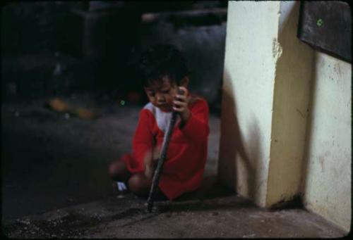 Child grating coconut