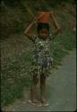 Child carrying a pot on her head