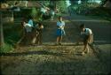 Children sweeping road