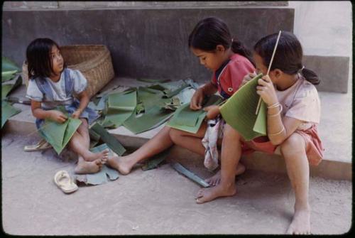 Children making banana-leaf plates