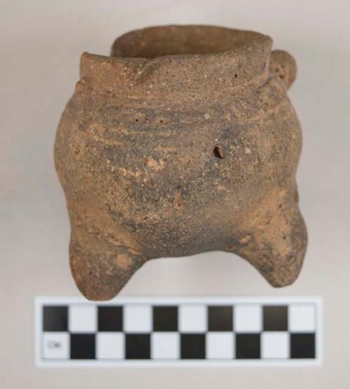 Small pottery tripod bowl - faint signs of incised and punctate decoration