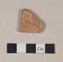 Coarse red bodied earthenware body sherd, with reduced black core, with possible buff slip