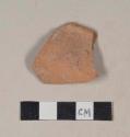 Red bodied earthenware rim sherd, unslipped, with reduced core, likely wheel thrown