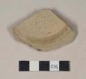 Buff bodied earthenware base sherd, unslipped, wheel thrown