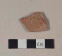Coarse red bodied earthenware body sherd, with red slip