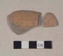 Red bodied earthenware rim sherds, with possible brown slip; two sherds crossmend