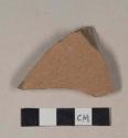 Coarse red bodied earthenware body sherd, with red slip, reduced core