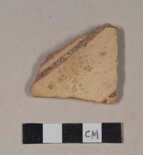 Red bodied earthenware body sherd, with buff slip and red slipped stripes, wheel thrown