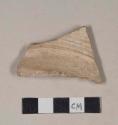 Molded, coarse red bodied earthenware body sherd, with buff slip