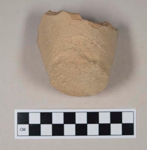 Coarse buff bodied earthenware base sherd, undecorated, wheel thrown