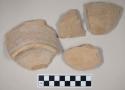 Coarse buff bodied earthenware base sherds, unslipped; three sherds crossmend