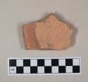 Coarse red bodied earthenware rim sherd, with red slip stripe on rim, possible partially reduced core