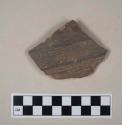 Gray and red bodied earthenware body sherd, with brown slip, wheel thrown