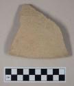 Coarse buff bodied earthenware rim sherd, unslipped