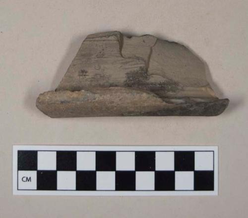 Red bodied earthenware rim sherd, with black slip, wheel thrown, partially burned interior