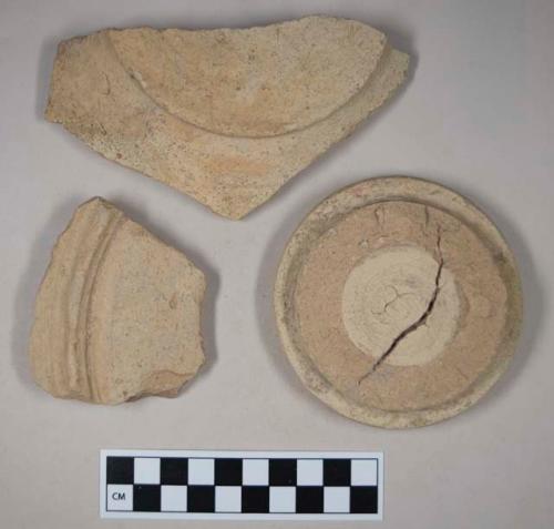 Coarse buff bodied earthenware base sherds, unslipped