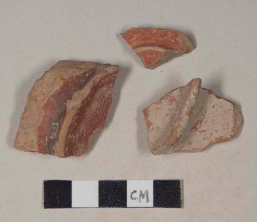 Red bodied earthenware base sherds, with red slip, one wheel thrown