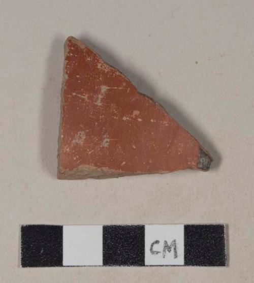 Red bodied earthenware body sherd, with red slip and red and black slipped stripes, wheel thrown