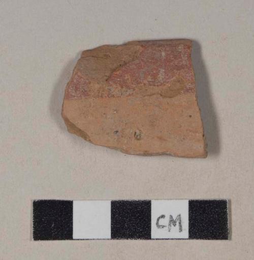 Red bodied earthenware rim sherd, with red slipped stripes, wheel thrown