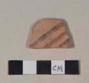 Red bodied earthenware body sherd, with black and red slipped stripes, wheel thrown