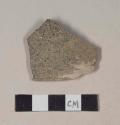 Buff bodied earthenware rim sherd, with black and green speckled slip, wheel thrown; crossmends with 39-18-60/21812