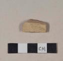 Coarse red bodied earthenware body sherd, with buff slip and incised decoration