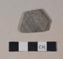 Gray bodied earthenware rim sherd, unslipped, wheel thrown