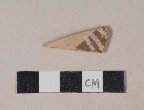 Buff bodied earthenware body sherd, with red and buff slipped stripes