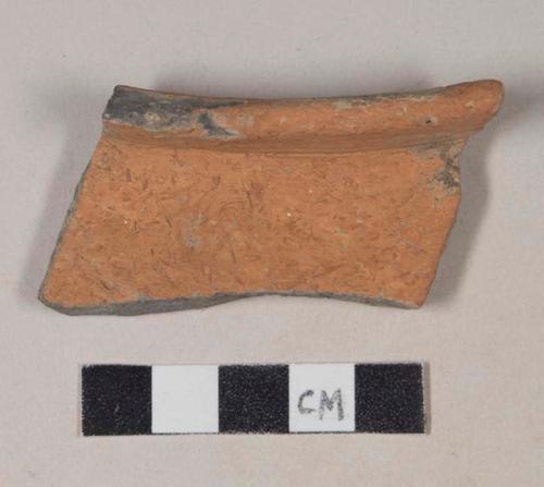 Coarse red bodied earthenware rim sherd, unslipped, reduced core