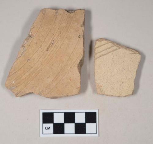 Coarse buff bodied earthenware body sherds, unslipped, with incised lines