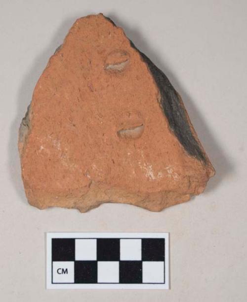 Coarse red bodied earthenware body sherd, unslipped, reduced core, with indented or incised marks