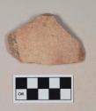 Coarse red bodied earthenware body sherd, with buff, black, and red slip