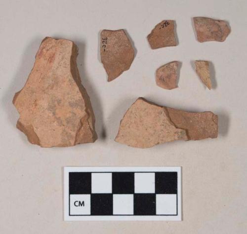 Red bodied earthenware body sherd, with buff slip, some with reduced core; four sherds crossmend; two sherds crossmend