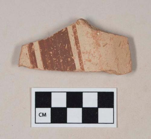 Coarse red bodied earthenware body sherd, with buff slip and red slipped stripes