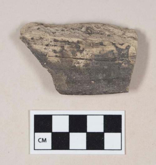 Coarse black bodied earthenware rim sherd, unslipped