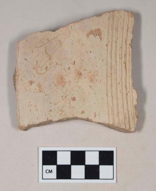 Coarse red bodied earthenware body sherd, with buff slip and incised straight and wavy lines, reduced core