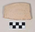 Coarse red bodied earthenware rim sherd, with buff slip