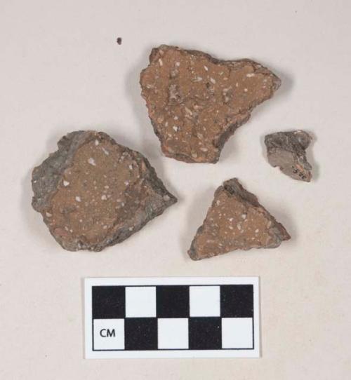 Coarse red bodied earthenware body sherds, with brown slip, reduced core, large white temper; four sherds crossmend