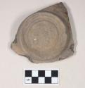 Coarse gray bodied earthenware base sherd, with gray slip, reduced core