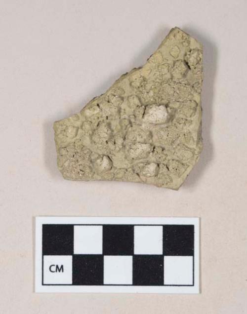 Green bodied earthenware body sherd, with blackened interior and rough, concreted exterior