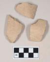 Coarse buff bodied earthenware rim sherds, unslipped, reduced core; three sherds crossmend